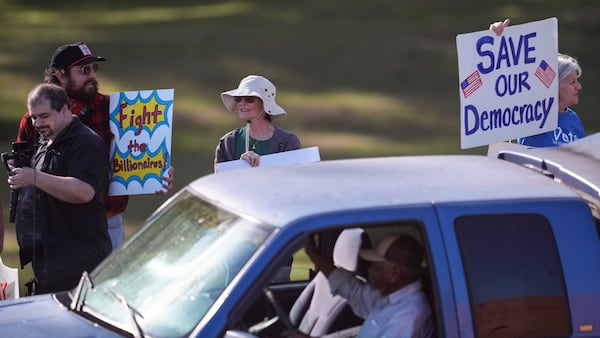 Demonstrators protest outside the venue where Rep. Marjorie Taylor Greene, R-Ga., speaks during a town-hall style meeting, Tuesday, April 15, 2025, in Acworth, Ga. (AP Photo/Mike Stewart)