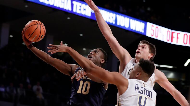Notre Dame guard TJ Gibbs (10) is defended by Georgia Tech's Ben Lammers and Brandon Alston (4) as he drives to the basket during the first half of an NCAA college basketball game Wednesday, Jan. 10, 2018, in Atlanta. (AP Photo/John Bazemore)