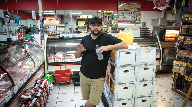Carlos Vazquez stands in his family’s store, the Mercado Real De La Villa, located near the Marietta flea market, which the city of Marietta is preparing to spend $5.8 million to buy and demolish. STEVE SCHAEFER / SPECIAL TO THE AJC