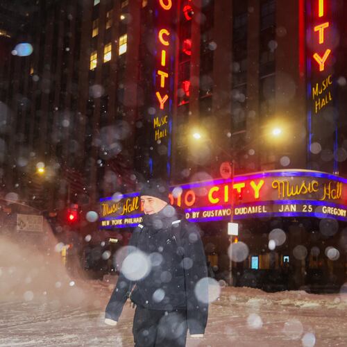 A pedestrian crosses the street near Radio City Music Hall during a winter storm, Sunday, Jan. 25, 2026, in New York. (AP Photo/Heather Khalifa)