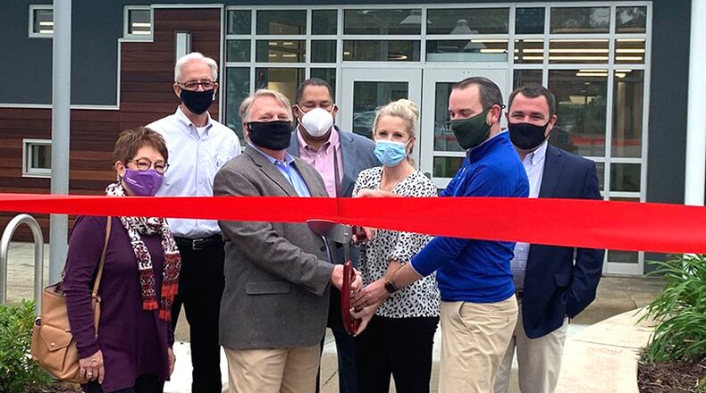Officials of Alpharetta and Ed Isakson YMCA cut the ribbon to officially open the Preston Ridge Community Center, next to the YMCA.