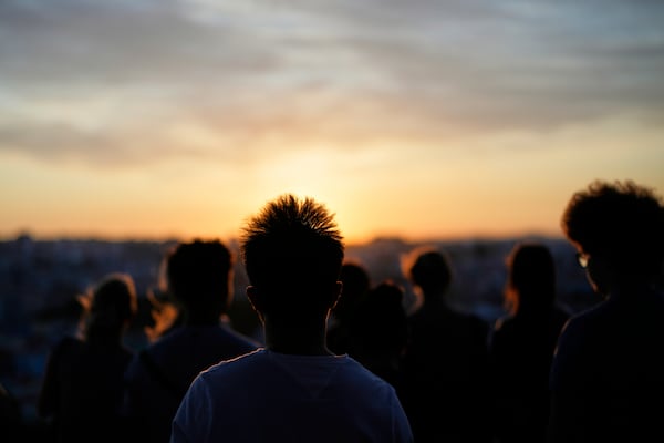 People watch the sun set from the Our Lady of the Hill viewpoint overlooking Lisbon, on a windy Friday, June 27, 2025. (AP Photo/Armando Franca)