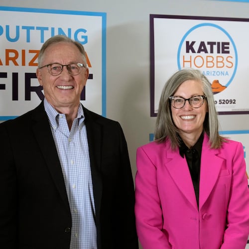 Arizona Democratic Gov. Katie Hobbs, right, poses for a photograph with her running mate for Lieutenant Governor John Giles, the former Republican Mesa, Ariz., mayor, Monday, Aug. 10, 2026, in Phoenix. (AP Photo/Ross D. Franklin)