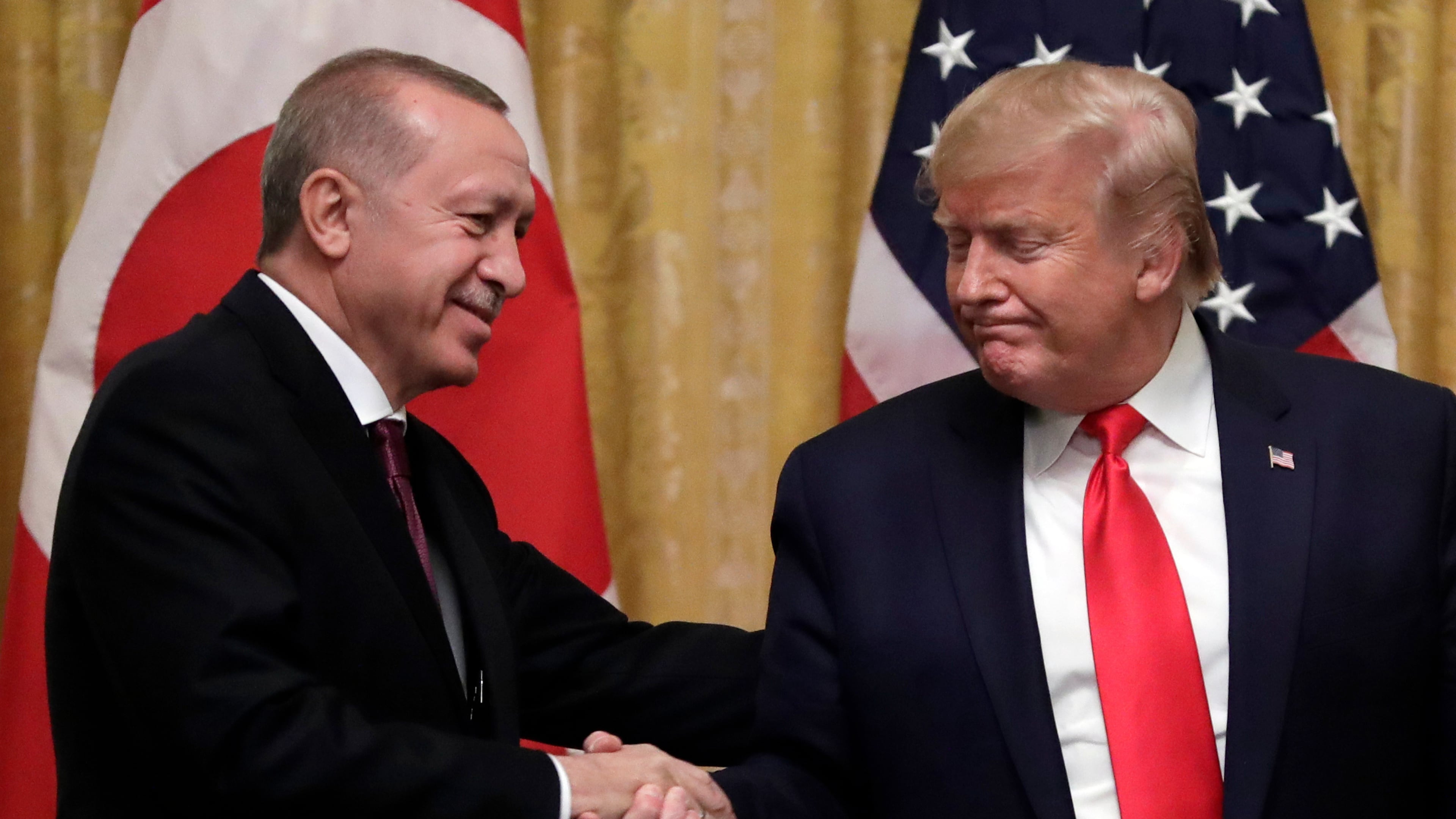 FILE - President Donald Trump shakes hands with Turkey's President Recep Tayyip Erdogan after a news conference in the East Room of the White House, Nov. 13, 2019, in Washington. (AP Photo/ Evan Vucci, File)