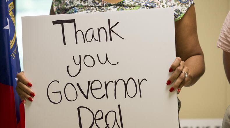 Gwinnett Intervention Education (G.I.V.E) Center West teacher Topaz Thompson holds a sign last month thanking Gov. Nathan Deal during a press conference for the Hungry for Education movement at Christ Church Episcopal Parish Hall in Norcoss,. This year is the first time in 15 years that Georgia school budgets are without austerity cuts. The Hungry for Education movement hopes to shed a light on Georgia school's full funding and gain support for its permanence from gubernatorial candidates Stacey Abrams and Brian Kemp.