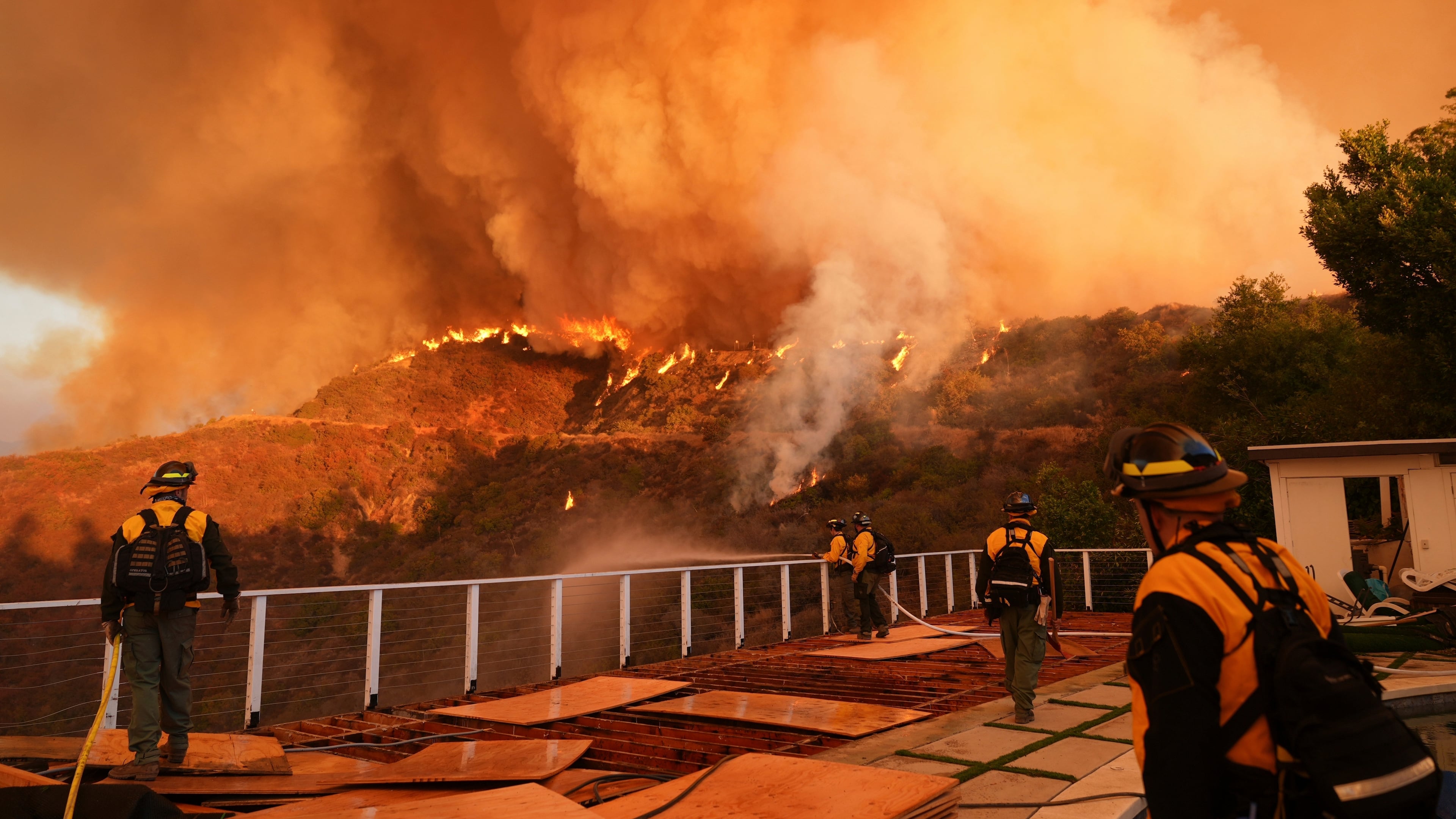 FILE - Fire crews monitor the Palisades Fire in Mandeville Canyon on Jan. 11, 2025, in Los Angeles. (AP Photo/Jae C. Hong, File)