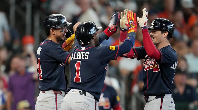 Atlanta Braves' Mike Yastrzemski (right) celebrates after his three-run home run with Mauricio Dubon (left) and Ozzie Albies (center) during the sixth inning of a baseball game against the Houston Astros, Sunday, Sept. 20, 2026, in Houston. (Karen Warren/AP)
