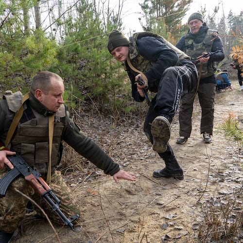 Civilians practice military skills on a training ground in Kharkiv region, Ukraine, Saturday, Nov. 15, 2025. (AP Photo/Andrii Marienko)