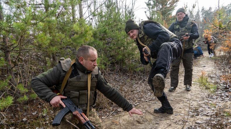 Civilians practice military skills on a training ground in Kharkiv region, Ukraine, Saturday, Nov. 15, 2025. (AP Photo/Andrii Marienko)