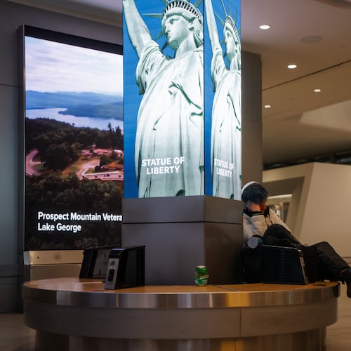 A traveler sleeps at Laguardia International Terminal on Saturday, Nov. 8, 2025, in New York. (AP Photo/Olga Fedorova)