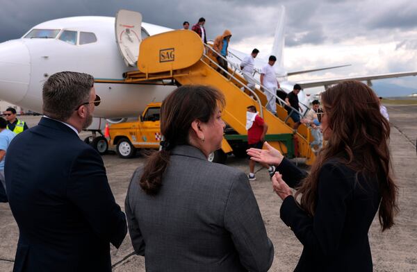 U.S. Homeland Security Secretary Kristi Noem, right, talks to ERO Regional Attaché Guadalupe "Lupita" Serna and U.S. Ambassador to Guatemala Tobin Bradley as they watch people deported from the United States disembark a repatriation flight, at La Aurora International Airport in Guatemala City, Thursday, June 26, 2025. (Anna Moneymaker/Pool Photo via AP)