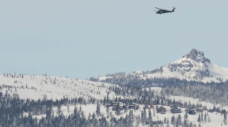 A U.S. Army Blackhawk helicopter flies toward the Castle Peak area as recovery efforts for a group of missing skiers continue in Truckee, Calif., Saturday, Feb. 21, 2026. (AP Photo/Godofredo A. Vásquez)