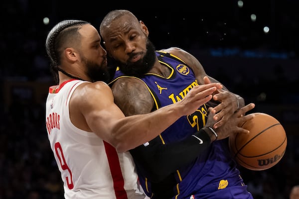 Los Angeles Lakers forward LeBron James (23) loses the ball as Houston Rockets forward Dillon Brooks (9) defends during the second half of an NBA basketball game in Los Angeles, Monday, March 31, 2025. (AP Photo/Kyusung Gong)