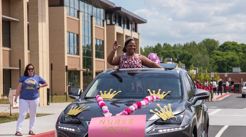 Cobb Schools Nursing Supervisor Melanie Bales, MSN, BSN, RN, CMS waves to the crowd during a drive-through event hosted by the Cobb Schools Foundation. Credit: Cobb County School District.