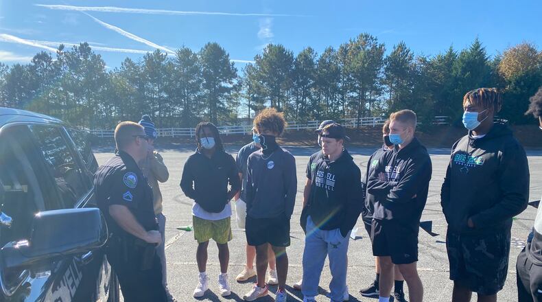 Officer Sam Wolfson and Sgt. Brittany Rodgers met with Roswell High School football team members and their parents. The officers told the teens what police are looking for during traffic stops and the teenagers got to ask questions about proper police procedures. Photo: Adrianne Murchison