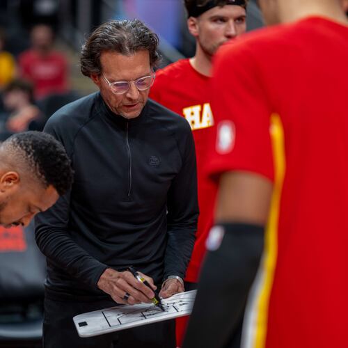 Atlanta Hawks head coach Quin Snyder, center, calls a play during the first half of an NBA basketball game against the Sacramento Kings, Saturday, March 28, 2026, in Atlanta. (AP Photo/Erik Rank)