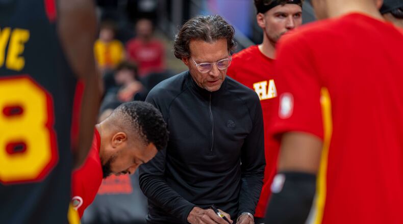 Atlanta Hawks head coach Quin Snyder, center, calls a play during the first half of an NBA basketball game against the Sacramento Kings, Saturday, March 28, 2026, in Atlanta. (AP Photo/Erik Rank)