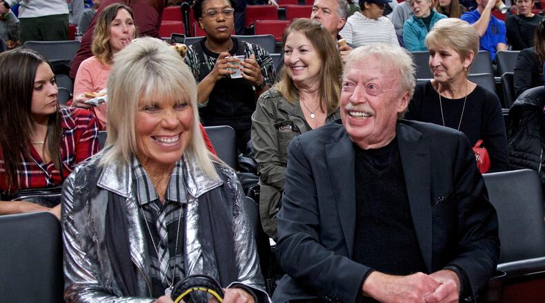 FILE - Phil Knight, right, and Penny Knight, watch the first half of an NCAA college basketball game in the Phil Knight Invitational tournament in Portland, Ore., Nov. 26, 2017. (AP Photo/Craig Mitchelldyer, File)