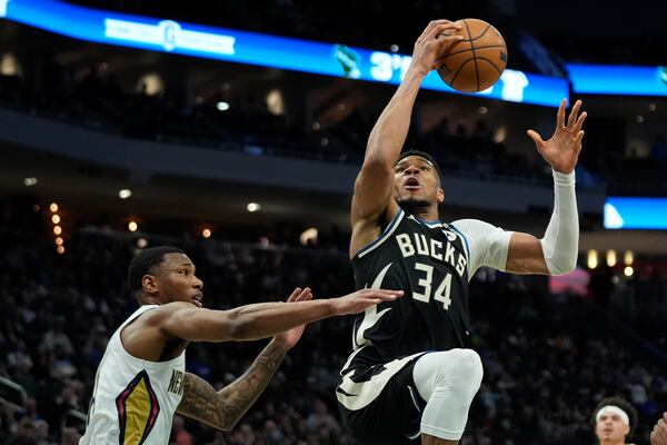 Milwaukee Bucks' Giannis Antetokounmpo (34) drives to the basket against New Orleans Pelicans' Jamal Cain, left, during the first half of an NBA basketball game Thursday, April 10, 2025, in Milwaukee. (AP Photo/Aaron Gash)