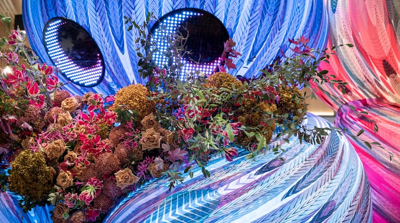 A garden of flowers is planted in the arms of an alien in Eness' artwork "Stem by Stem – Alien Boy Gives Me Flowers,” which will be installed in Woodruff Park on Feb. 13. (Courtesy of Gavin Jowitt)