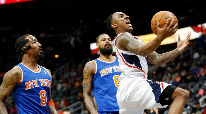 Atlanta Hawks point guard Jeff Teague, right, drives past New York Knicks shooting guard J.R. Smith (8) and center Tyson Chandler (6) to score in the first half of an NBA basketball game Saturday, Feb. 22, 2014, in Atlanta. (AP Photo/John Bazemore)
