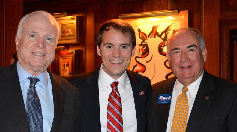 John McCain, Evan Karanovich and Alec Poitevint pose at a campaign event for Georgia U.S. Sen. David Perdue.