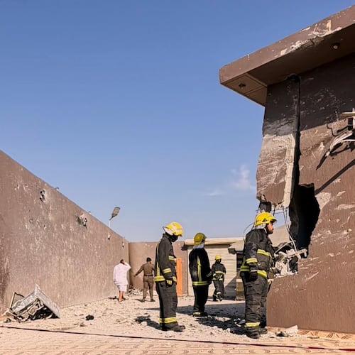 This photo provided by the Saudi Press Agency shows firefighters inspecting damage to a building caused by falling debris from a drone that Saudi authorities said was launched by Yemen's Houthi rebels and intercepted over Taif province, western Saudi Arabia, Thursday, Sept. 17, 2026. (Saudi Press Agency via AP)