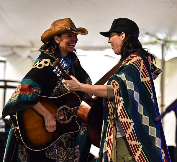 Barb Moose Carbon (left) and Arrie Bozeman in concert. “We circle up before each show,” Carbon says, “and (drummer) Richie (Jones) reminds us of peaks and valleys — that we’re taking the audience on a journey." (Courtesy of Melissa Goehner)