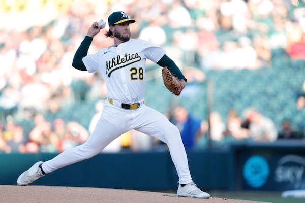 Athletics starting pitcher Mitch Spence throws to an Atlanta Braves batter during the first inning of a baseball game Wednesday, July 9, 2025, in West Sacramento, Calif. (AP Photo/Sergio Estrada)