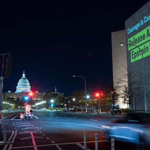 A World Without Exploitation projection is seen on the wall of the National Gallery of Art calling on Congress to vote yes on the Epstein files transparency act in Washington, Monday, Nov. 17, 2025. (AP Photo/Jose Luis Magana)