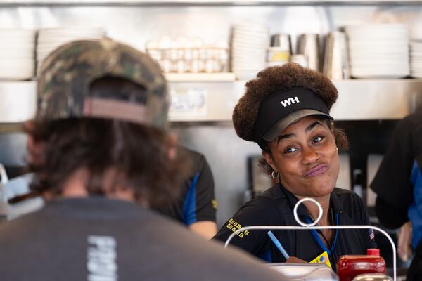 Shanell Collins waits for a customer to make up his mind at the Waffle House on Peachtree Road in Brookhaven on Friday, Aug. 14, 2026. (Ben Gray for the AJC)