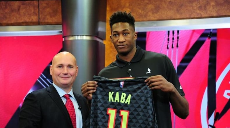 General Manager Travis Schlenk of the Atlanta Hawks introduces new draft pick Alpha Kaba during a press conference on June 26, 2017 at Fox Studios in Atlanta, Georgia.