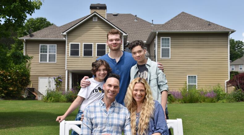 Jason and Heather DeVan, with their sons (background from left) Cassius, 12, P.K., 18, and Tristan, 16, are filmmakers who moved from the Los Angeles area to metro Atlanta last year. They are in production on their second feature film, which they are currently shooting at locations in Decatur and Flowery Branch. HYOSUB SHIN / HSHIN@AJC.COM