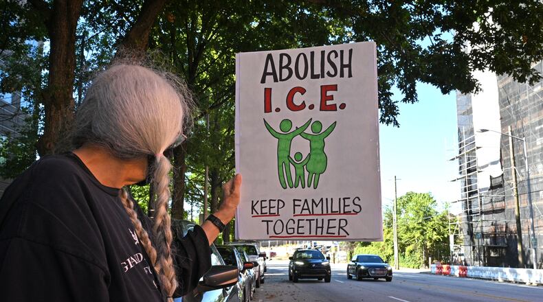 September 23, 2021 Atlanta - A protester holds a sign during a rally to demand Biden shut down detention centers, free them all and stop deportation outside ICE Atlanta Field Office on Thursday, September 23, 2021. (Hyosub Shin / Hyosub.Shin@ajc.com)