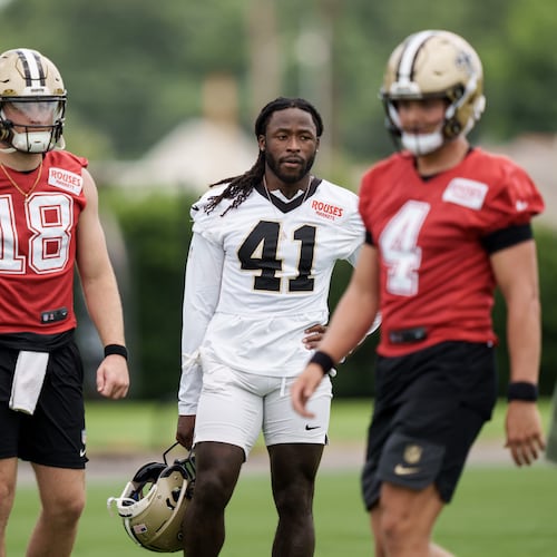 New Orleans Saints running back Alvin Kamara (41), second right, watches practice with quarterback Hunter Dekkers (18), second left, during the NFL football team's practice in Metairie, La., Wednesday, June 17, 2026. (AP Photo/Matthew Hinton)
