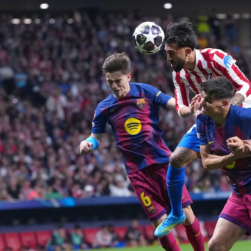 Atletico Madrid's Nicolas Gonzalez, top, heads the ball during the Champions League quarterfinal second leg soccer match between Atletico Madrid and Barcelona in Madrid, Spain, Tuesday, April 14, 2026. (AP Photo/Manu Fernandez)