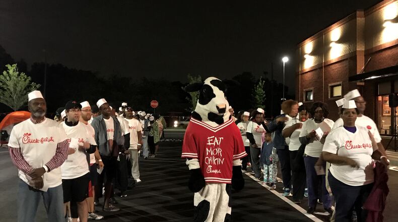 The 100 winners of Chick-fil-A meals for a year lined up with the Chick-fil-A mascot early on April 27 to receive their prize. Photo: Ligaya Figueras