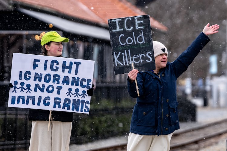 Caroline Campbell (left) and Erin Campbell protest Immigration and Customs Enforcement in Woodstock in January. (Ben Hendren for the AJC 2026)