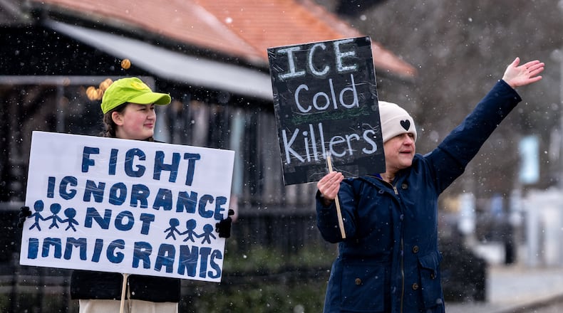 Caroline Campbell (left) and Erin Campbell protest Immigration and Customs Enforcement in Woodstock in January. (Ben Hendren for the AJC 2026)