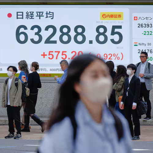 People stand in front of an electronic stock board showing Japan's Nikkei index at a securities firm Monday, May 11, 2026, in Tokyo. (AP Photo/Eugene Hoshiko)