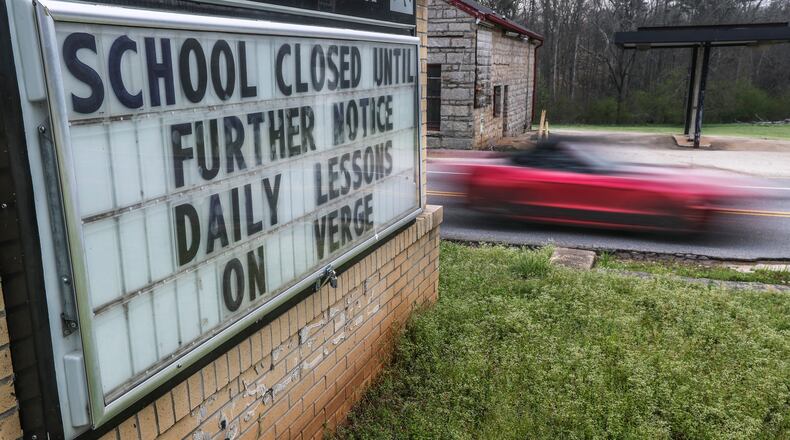 School closings came quickly as COVID-19 started taking hold in Georgia in March 2020. This sign at Murphey Candler Elementary School in Lithonia, DeKalb County, shared the message on Wednesday, March 18, 2020. (John Spink / John.Spink@ajc.com)