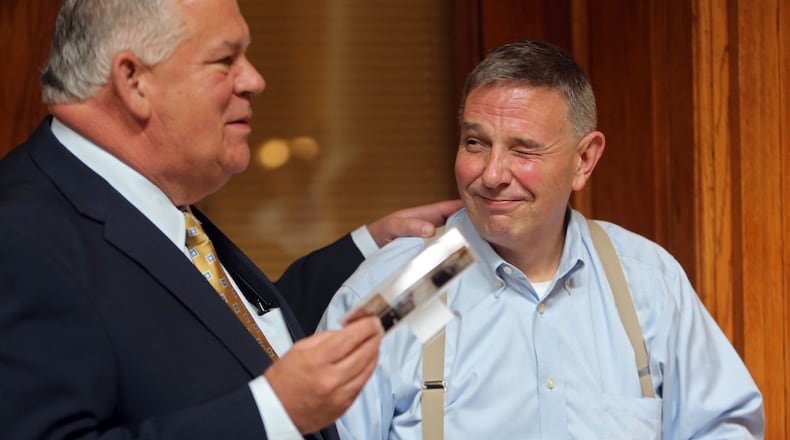 LEDE PHOTO: July 24, 2013 Atlanta: Robby Rivers, right, clerk of the Georgia House of Representatives since 1991, winks at House Speaker David Ralston during a Wednesday afternoon July 24, 2013 retirement party at the State Capitol as Ralston tells a story about Rivers climbing over the Speaker’s desk at the close of the 2013 Legislative session. Rivers has been an institution at the Capitol for 27 years, the first six of which were spent as attorney for former House Speaker Tom Murphy. BEN GRAY / BGRAY@AJC.COM