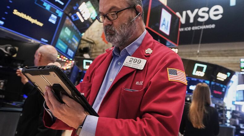 Trader William Lawrence works on the floor of the New York Stock Exchange, Thursday, Dec. 11, 2025. (AP Photo/Richard Drew)