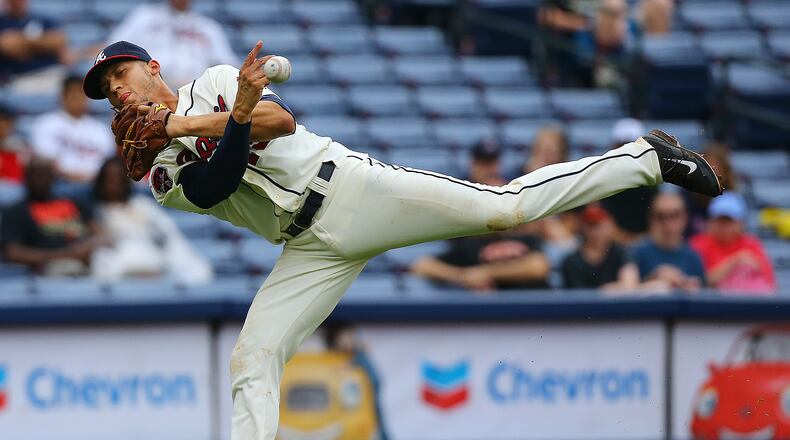 Braves' Andrelton Simmons makes a play on a ground ball hit by the Phillies' Marlon Byrd, throwing to first in 2014. CURTIS COMPTON / CCOMPTON@AJC.COM