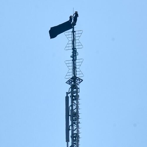 A person is shown atop the spire of the Empire State Building, in New York, Wednesday, July 1, 2026. (AP Photo/Richard Drew)
