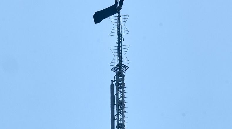 A person is shown atop the spire of the Empire State Building, in New York, Wednesday, July 1, 2026. (AP Photo/Richard Drew)