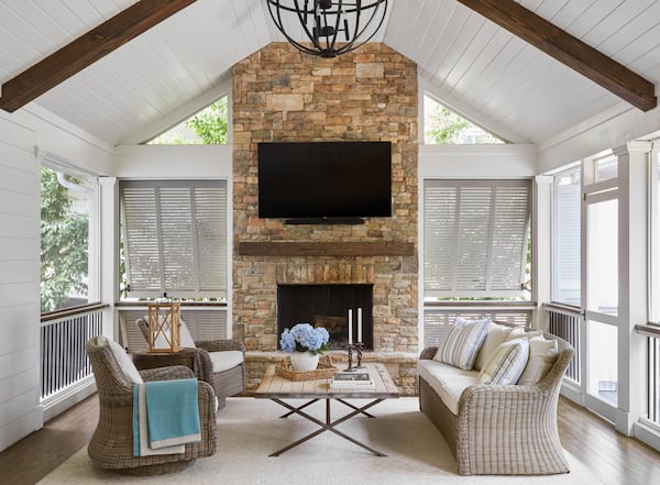 This screened-in porch offers not only views of the outdoors, but the sounds and sensations of nature. Courtesy of Kelly Blackmon of Emily Followill Photography/Liz Williams Interiors