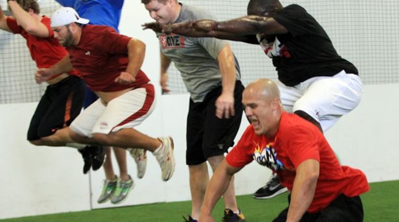 FILE PHOTO: Atlanta Falcons players, led by linebacker Coy Wire, right, and quarterback Matt Ryan, have gotten together at a local training facility and high school to work out together during the lockout back in 2010. (By Curtis Compton/Ccompton@ajc.com)