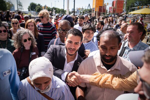 Abdul El-Sayed (center) leaves a news conference at the Spirit of Detroit after winning the Democratic nomination for U.S. Senate in Michigan on Wednesday. (Julia Demaree Nikhinson/AP)