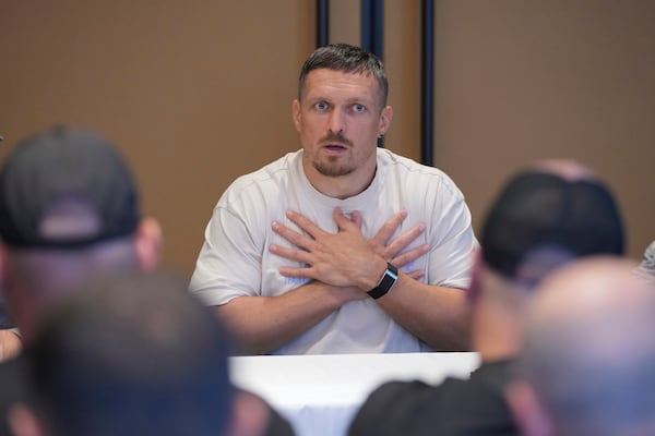 Ukraine's boxer Oleksandr Usyk speaks as he meets the Ukrainian war veterans, who are employees of Ukrainian power company DTEK at a hotel in Battersea Park in London, Thursday, July 17, 2025 ahead of the undisputed heavyweight champion boxing fight between Britain's Daniel Dubois and Oleksandr Usyk on Saturday. (AP Photo/Kin Cheung)